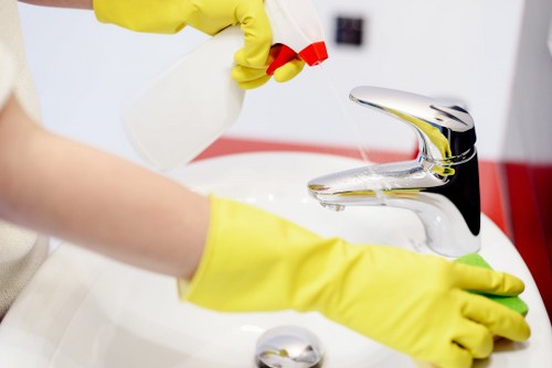 Professional technician cleaning a fabric chair with specialized equipment